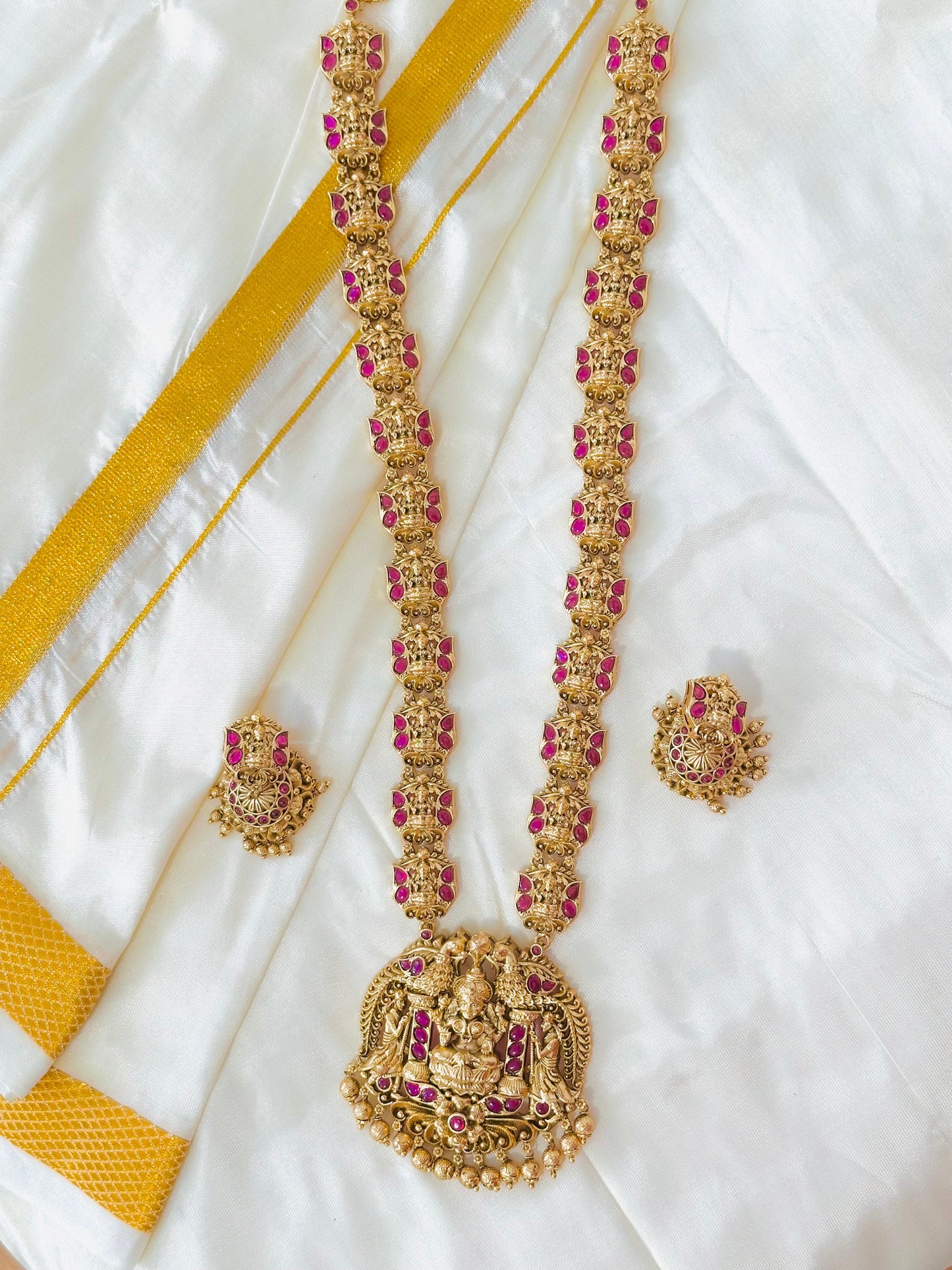 Grand Antique Gold-Toned Lakshmi Haram Necklace and Stud Earring Set with Ruby Accents