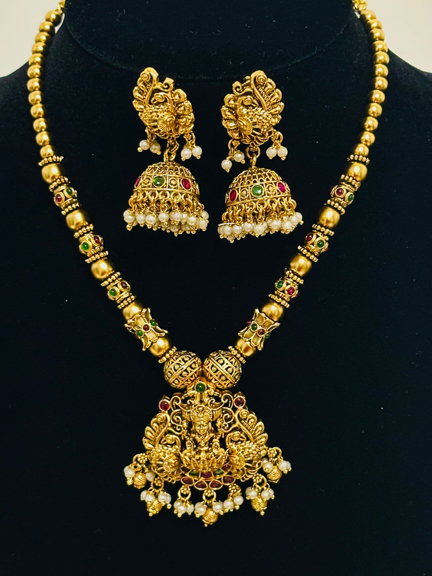Traditional Indian Gold Pendant Necklace and Jhumka Earring Set with Lakshmi Motif