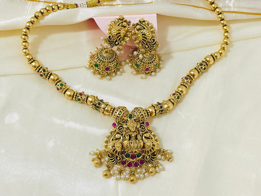 Traditional Indian Gold Pendant Necklace and Jhumka Earring Set with Lakshmi Motif